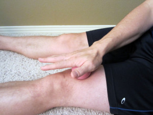 Dr. Ben uses a lacrosse ball to work the tissue above the patella.