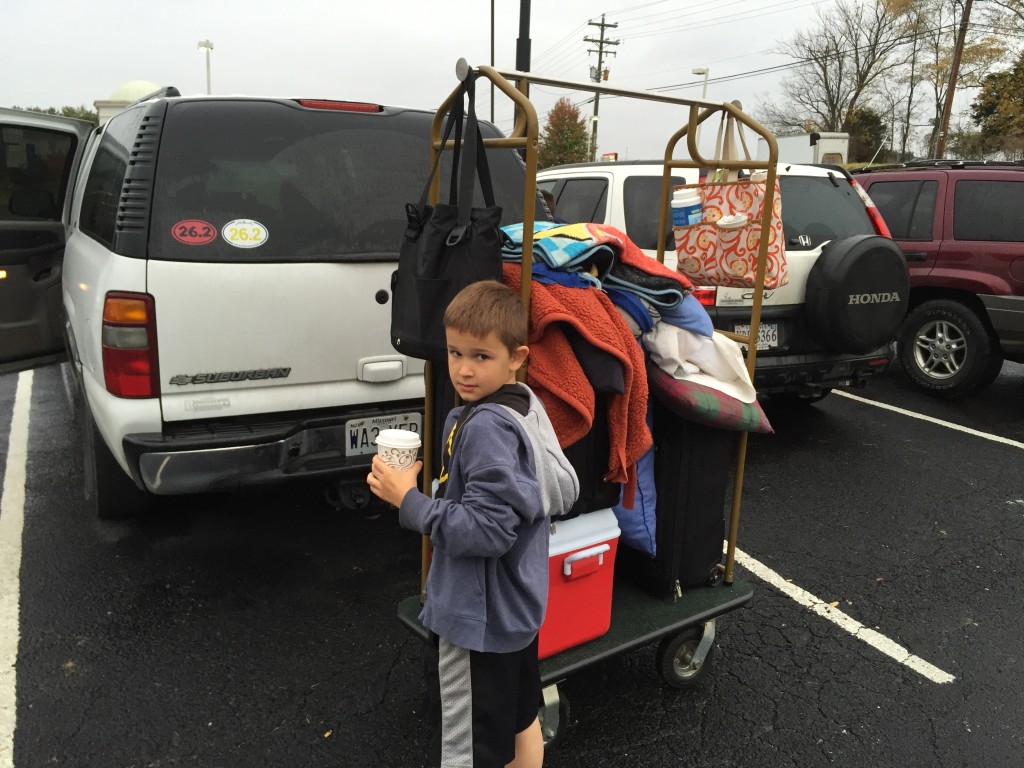 This a  familiar sight.  Checking out of a hotel somewhere.  Gavin is holding my coffee (he's too young to drink).